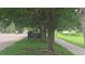 Street view of Green Valley West Ranch Park sign surrounded by mature trees and lush green landscape at 4543 Cathay St, Denver, CO 80249