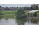 Scenic view of community with a pond and covered picnic tables near landscaped green space and buildings at 4543 Cathay St, Denver, CO 80249