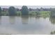 Serene pond reflecting the sky, with birds swimming and lush greenery surrounding the water's edge at 4543 Cathay St, Denver, CO 80249