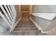 Carpeted staircase with white railings, leading to the next level of the home at 4543 Cathay St, Denver, CO 80249