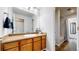 Bathroom with wood vanity, large mirror, and shower/tub combo at 8865 Federal Blvd # 202, Westminster, CO 80260