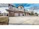 Townhouse exterior with multiple garages and a spacious driveway at 8865 Federal Blvd # 202, Westminster, CO 80260