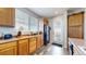 Kitchen features wood cabinets, black appliances, and a door to outside at 8865 Federal Blvd # 202, Westminster, CO 80260
