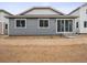 Backyard view showcasing the home's exterior, windows, and sliding glass door at 45916 Gentry Ave, Bennett, CO 80102