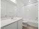 Well-lit bathroom featuring a shower-tub combo, a modern vanity with storage, and sleek fixtures at 45916 Gentry Ave, Bennett, CO 80102