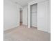 Cozy bedroom with neutral carpet, a closet with sliding doors, and ample natural light at 45916 Gentry Ave, Bennett, CO 80102