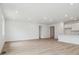 Bright living room featuring wood-look floors, recessed lighting, and white walls at 45916 Gentry Ave, Bennett, CO 80102