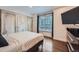 Bedroom showcasing a window, closet, and dresser with wall-mounted TV at 2286 S Pitkin Way # A, Aurora, CO 80013