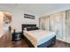 Bedroom with hardwood floors, black and white cityscape art, and closet at 2286 S Pitkin Way # A, Aurora, CO 80013