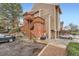 Multi-story townhome with wood siding, brick accents, and a wooden staircase leading to a private deck at 2286 S Pitkin Way # A, Aurora, CO 80013