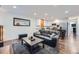 Open living space showing a dark leather sofa and a white kitchen with stainless steel appliances at 2286 S Pitkin Way # A, Aurora, CO 80013