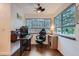 Office space featuring a dark wood desk, an ergonomic chair, and natural light from the windows at 2286 S Pitkin Way # A, Aurora, CO 80013