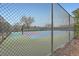 Community tennis court secured by a chain-link fence, ready for recreational play at 2286 S Pitkin Way # A, Aurora, CO 80013