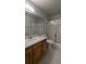 Well-lit bathroom featuring tile flooring, marble countertops and a shower with glass doors at 10150 E Virginia Ave # 308, Denver, CO 80247