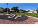 Welcome to the community, as seen with this OP sign in the common area with landscaping and trees at 10150 E Virginia Ave # 308, Denver, CO 80247