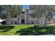 Exterior shot of building with number 19 in the center, and large trees framing the sides of the building at 10150 E Virginia Ave # 308, Denver, CO 80247