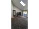 The spacious carpeted living room features a skylight and access to sliding glass door at 10150 E Virginia Ave # 308, Denver, CO 80247