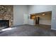 The living room features carpet, a stone fireplace, and a view to the kitchen with modern appliances at 10150 E Virginia Ave # 308, Denver, CO 80247
