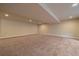 Large finished basement area with neutral walls and carpet at 2420 Nicholson St, Berthoud, CO 80513
