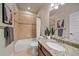 Bathroom with granite countertop vanity, tiled shower, and bathtub at 2420 Nicholson St, Berthoud, CO 80513
