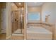 Elegant bathroom featuring a shower and soaking tub at 2420 Nicholson St, Berthoud, CO 80513