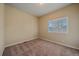 Bright bedroom with neutral walls and carpet, featuring window with shutters at 2420 Nicholson St, Berthoud, CO 80513