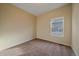 Simple bedroom with neutral walls and carpet, featuring a window at 2420 Nicholson St, Berthoud, CO 80513