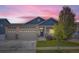 Two-story house with blue and beige siding, two-car garage, and landscaping at 2420 Nicholson St, Berthoud, CO 80513