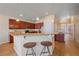 Kitchen with breakfast bar and hardwood floors at 2420 Nicholson St, Berthoud, CO 80513