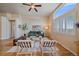 Living area with hardwood floors, large window with plantation shutters, and seating area at 2420 Nicholson St, Berthoud, CO 80513