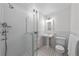 All-white bathroom featuring tiled shower with glass enclosure and pedestal sink at 637 N Franklin St, Denver, CO 80218