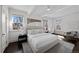 Light filled main bedroom with hardwood floors, large windows, modern art and a ceiling fan at 637 N Franklin St, Denver, CO 80218
