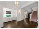 Spacious home entryway featuring hardwood floors, staircase, and elegant lighting fixtures at 637 N Franklin St, Denver, CO 80218