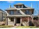 Inviting exterior featuring a covered porch, brick facade, and well-maintained landscaping at 637 N Franklin St, Denver, CO 80218