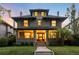 Home exterior features front porch, green lawn, and mature shade tree at 637 N Franklin St, Denver, CO 80218