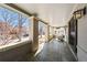 Cozy covered front porch with tile flooring and a comfortable seating area, perfect for relaxing outdoors at 637 N Franklin St, Denver, CO 80218
