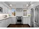 Modern kitchen with stainless steel appliances, white cabinets, granite countertops and designer lighting at 637 N Franklin St, Denver, CO 80218