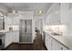 Bright kitchen featuring stainless steel refrigerator, white cabinetry, and granite countertops at 637 N Franklin St, Denver, CO 80218