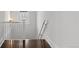 Staircase with hardwood floors and white railings, leading to the upper level at 637 N Franklin St, Denver, CO 80218