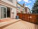 Wooden deck with sliding door access to the home and fenced in outdoor space at 2578 E Nichols Cir, Centennial, CO 80122