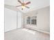 Light filled bedroom with a ceiling fan, closet, and large window with natural light at 2578 E Nichols Cir, Centennial, CO 80122