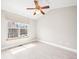 Bright bedroom with large window, ceiling fan, light wood floors, and neutral paint at 2578 E Nichols Cir, Centennial, CO 80122
