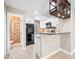 Modern kitchen with white cabinetry, black appliances, and a unique wine rack adding character to the space at 2578 E Nichols Cir, Centennial, CO 80122