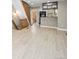 Open-concept living area showcases new wood floors, staircase, and leads to a view of the kitchen and powder room at 2578 E Nichols Cir, Centennial, CO 80122
