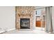 Inviting living room features a stone fireplace, sliding glass doors to a deck, and light wood-look flooring at 2578 E Nichols Cir, Centennial, CO 80122