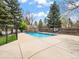 Community pool surrounded by lush trees and a secured fence for resident enjoyment at 2578 E Nichols Cir, Centennial, CO 80122