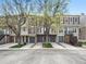 Charming townhomes with attached garages and mature trees line the street, showing appealing exterior features at 2578 E Nichols Cir, Centennial, CO 80122