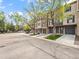 Attractive townhomes with attached garages on a tree-lined street, enhanced by well-maintained landscaping at 2578 E Nichols Cir, Centennial, CO 80122