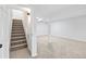 Finished basement with neutral walls and carpet, and stairway at 2090 S Fairplay St, Aurora, CO 80014