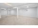 A large basement area with light-colored carpet, bright white walls, and recessed lighting at 2090 S Fairplay St, Aurora, CO 80014